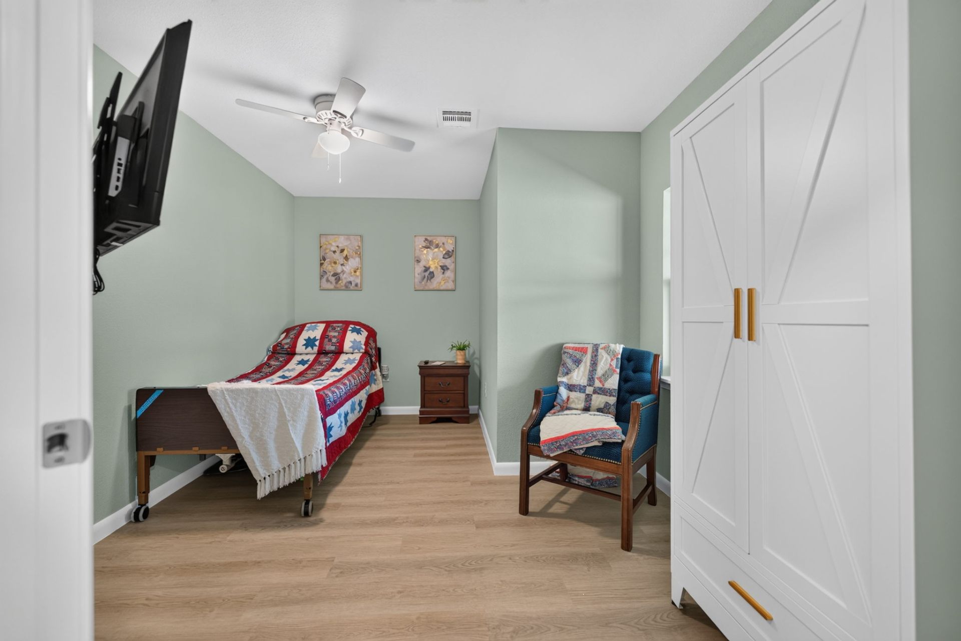 A private suite at Aspen with a comfortable bed, quilted throws, seating, and warm natural light