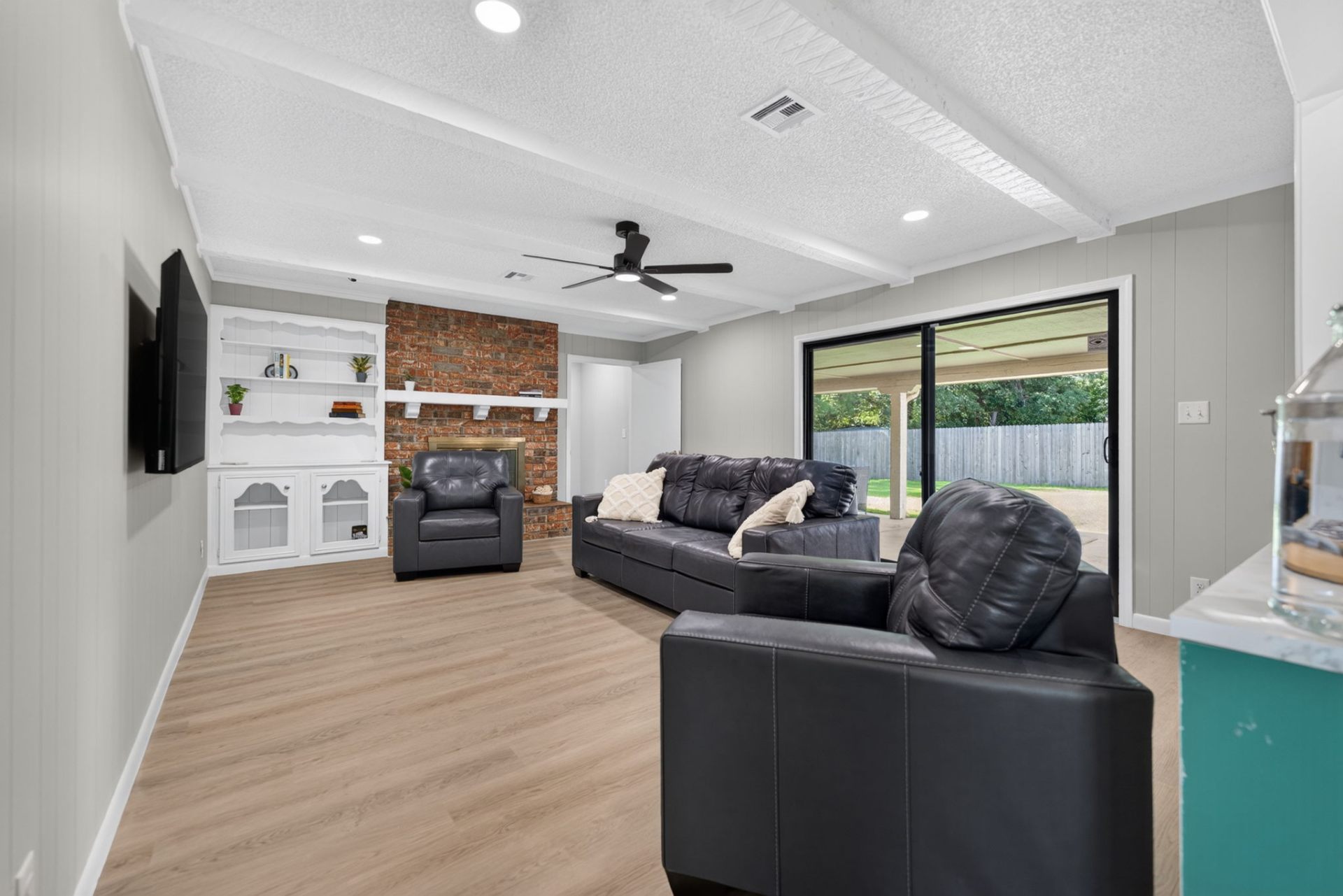 The shared living area just outside the suites, with comfortable seating, a fireplace, and natural light